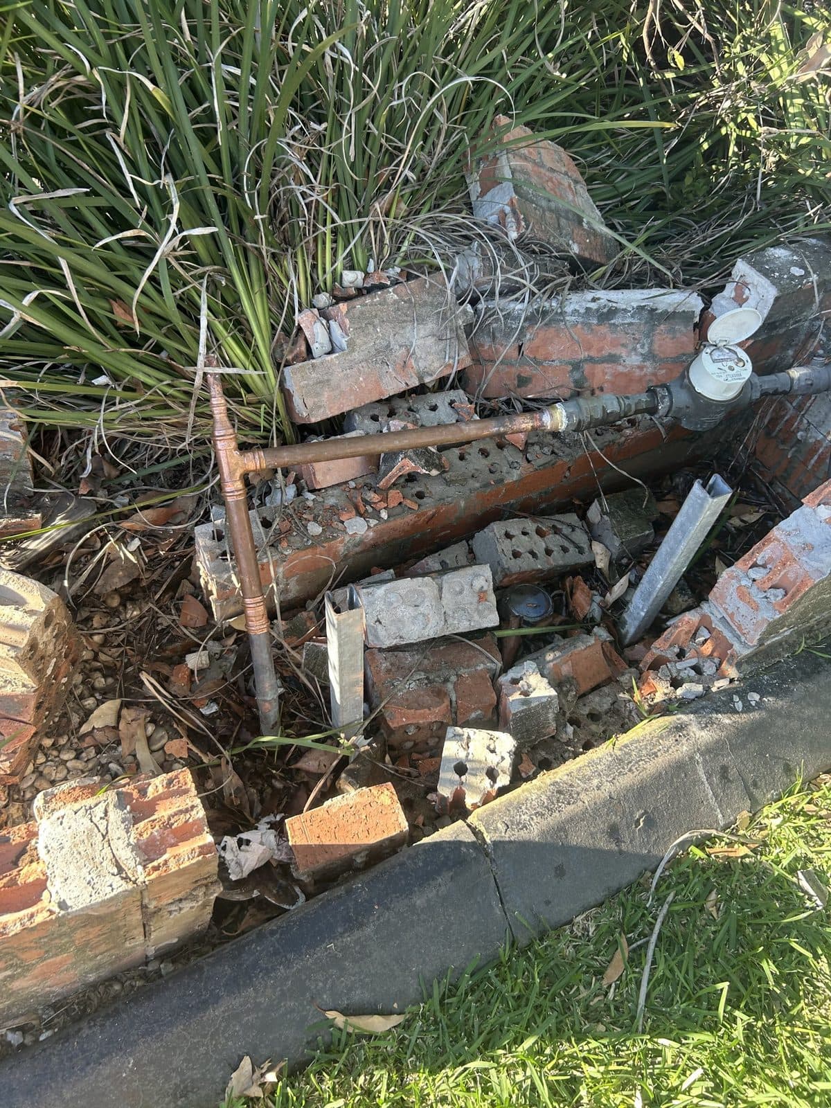 New copper pipework run to the water meter among the fallen bricks