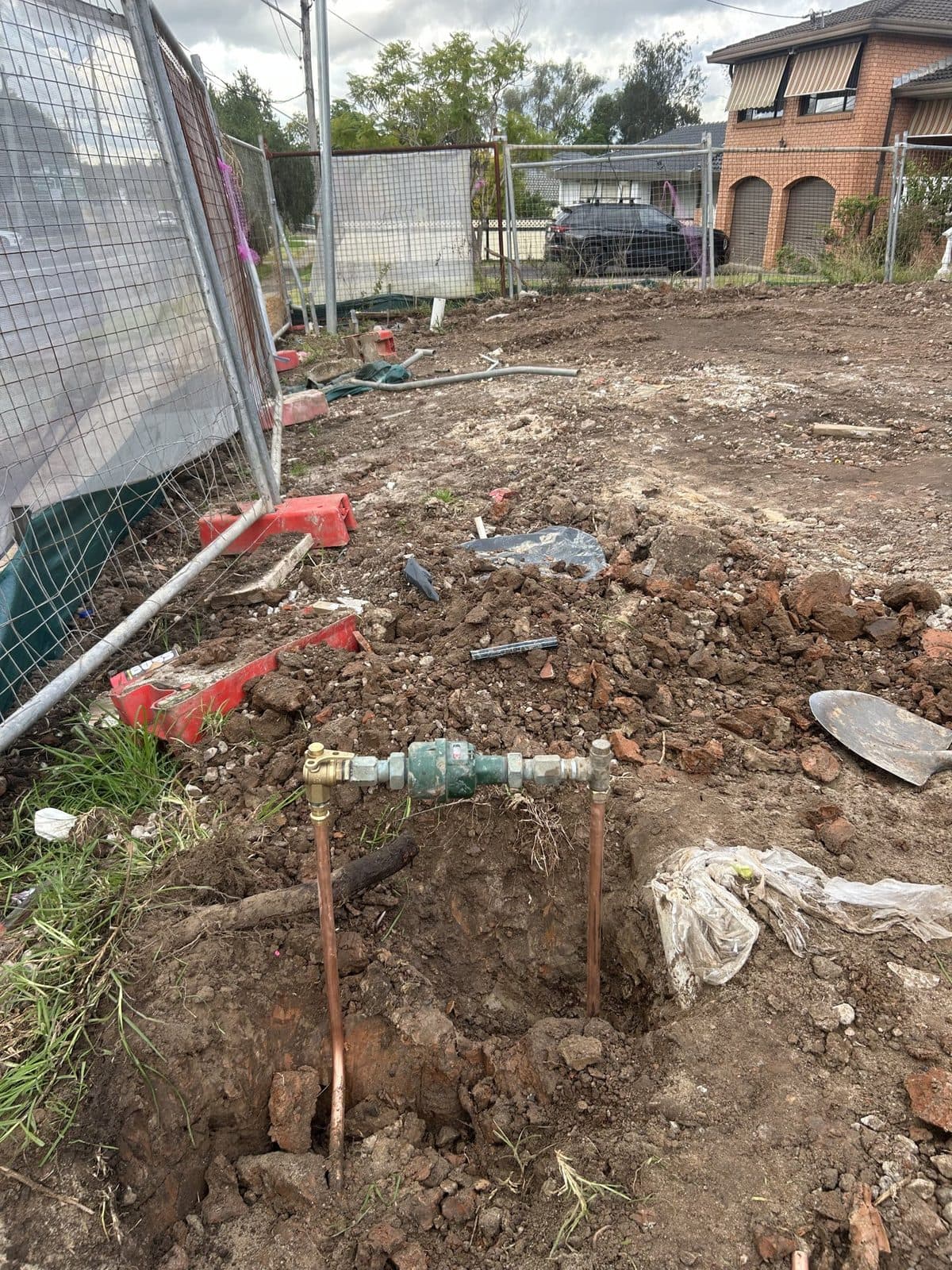 New water service with a meter and valve, in freshly dug ground on a cleared block